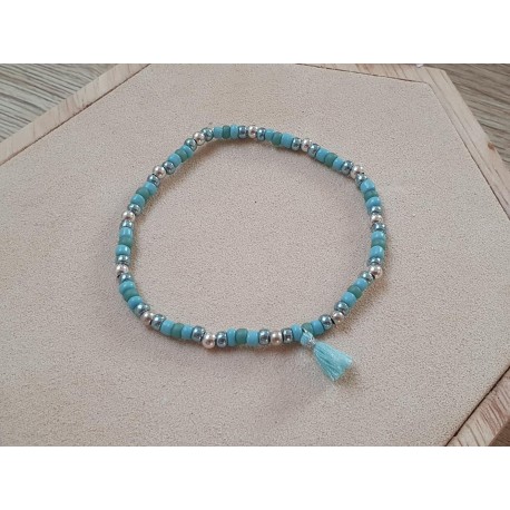 Turquoise armband met goudkleurige accenten